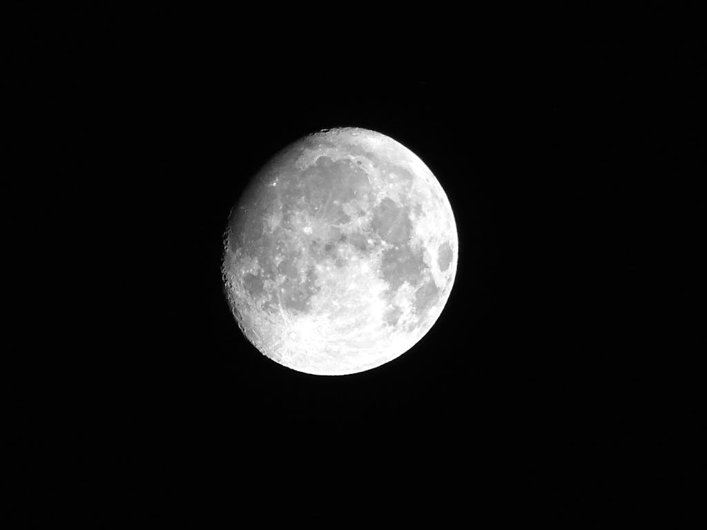 A luminous full moon against a dark night sky, showcasing intricate lunar craters.